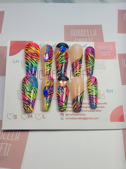 A picture shoiwing the custom press on nails by Norbella crafts - Rainbow Zebra Madness