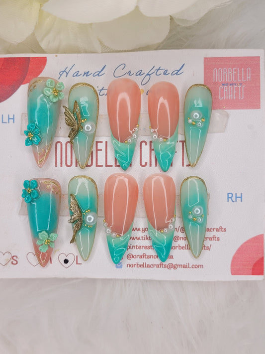 Set of decorative false nails with floral designs on a branded card.