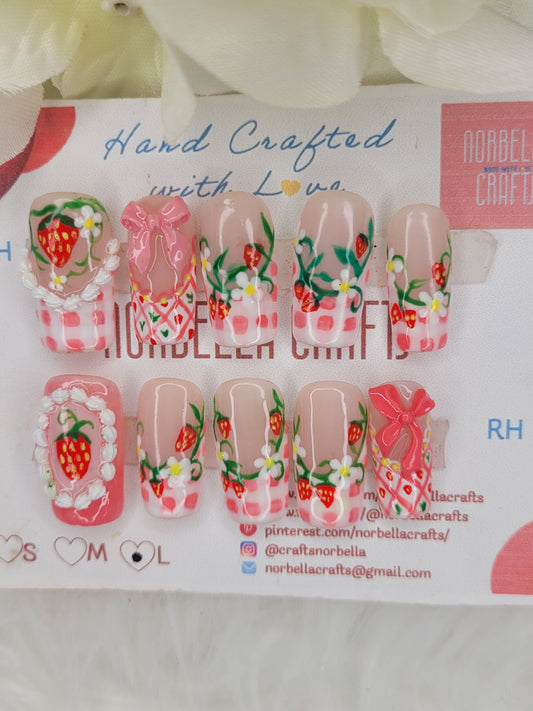 Nail art stickers with strawberry and checkered designs on a branded backing