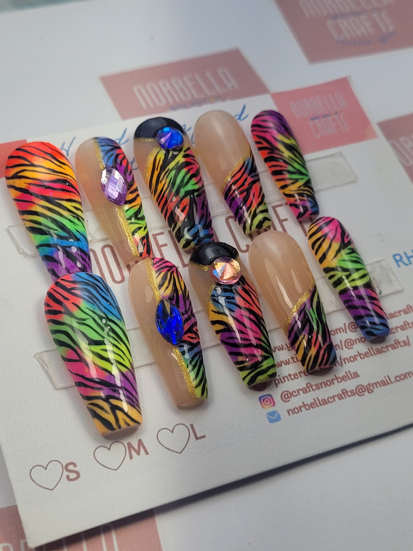 a picture showing the rainbow animal design from norbella crafts stuck on a nail card