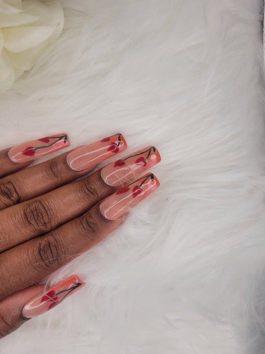 Hand with red and black nail art on a white background