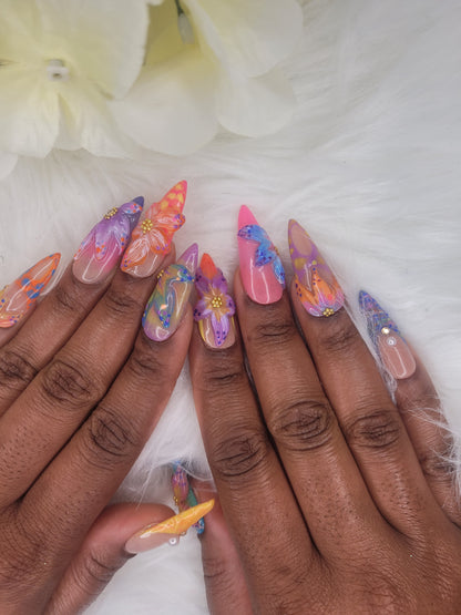 Picture of a woman showcasing her nails. Her left and right hand